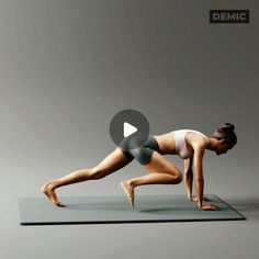 a woman is doing yoga on a mat with her legs spread out in the air