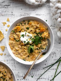 two bowls filled with soup and topped with sour cream