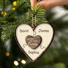 personalized wooden heart ornament hanging from a christmas tree