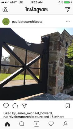 an iron gate in front of a brick house