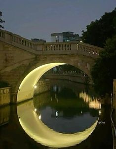 a bridge that is over some water at night