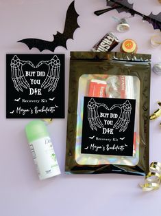 the contents of a halloween treat bag laid out on a white surface with bats, candy and candies