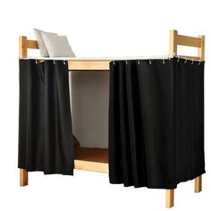 a bunk bed with black curtains on it