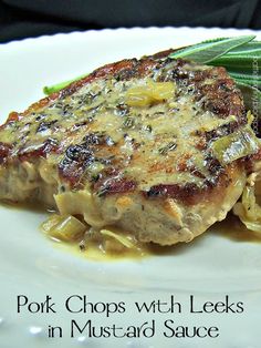 pork chops with leeks in mustard sauce on a white plate, ready to be eaten