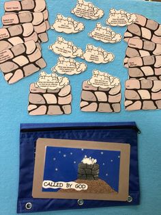 a bulletin board with some writing on it next to a blue bag filled with magnets