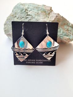 These gorgeous earrings are Navajo handmade handcrafted by artist Elsie Woody. Elsie use to be one of Tommy Singers silversmith's now that he has passed Elsie is still producing his designs in this pair of earrings Elsie has used a piece of sleeping beauty turquoise that is mined in Globe Arizona and underneath the stone she has put the water symbol. The earrings are sterling silver and handstamped the artist has also oxidized behind the water symbol. These earrings are light weight and comforta Artisan Turquoise Nickel-free Earrings, Artisan Nickel-free Turquoise Earrings, Artisan Turquoise Pierced Earrings, Handmade Artisan Sterling Silver Earrings, Artisan Stamped 925 Earrings, Southwestern Blue Earrings For Gift, Artisan Oxidized Dangle Earrings, Handmade Artisan Silver Earrings, Artisan Turquoise Pierced Jewelry