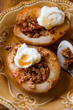 two baked potatoes topped with granola and yogurt on a yellow platter