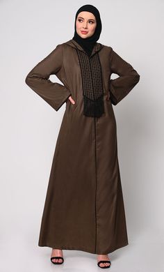 Elevate your modest fashion with our Hoodie Abaya, where contemporary style meets traditional elegance. Crafted from high-quality fabric, this abaya features intricate check embroidery, adding a touch of sophistication. The front is adorned with charming tassels that sway gracefully with your movements, creating a dynamic silhouette. Designed for both comfort and style, it includes two practical pockets, perfect for keeping essentials close at hand. Whether worn casually or for special occasions Hoodie Abaya, Abaya With Pockets, Check Embroidery, Brown Hoodie, Modest Fashion, Black Hoodie, Ankle Length, Contemporary Style, Quality Fabric