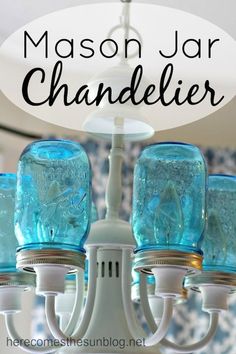 mason jar chandelier with blue glass jars hanging from it's sides and the words mason jar chandelier above them