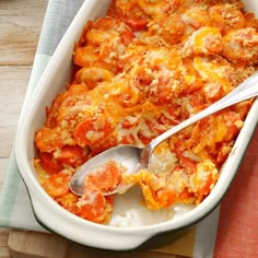 a casserole dish with tomatoes and cheese on top, ready to be eaten