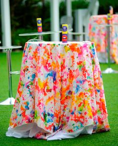 colorful table cloths are set up on the grass