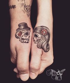 two people with matching tattoos on their hands