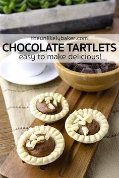 chocolate tartles are on a wooden tray next to a bowl of green beans