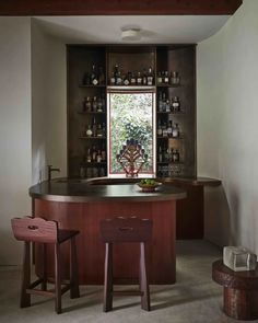 a bar with stools in front of a window