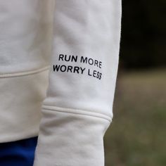 a close up of a person's arm with the words run more worry less printed on it