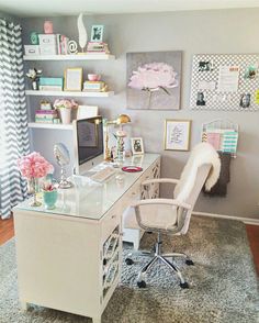 a desk with a chair and pictures on the wall behind it in a home office