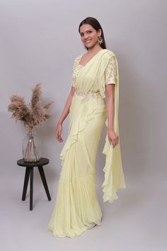 Ruffle saree with blouse/yellow ruffle saree with stitched blouse/ saree belt with blouse /light yellow  silk ruffle saree / saree with belt / belt sari/ voggish / yellow cocktail saree     Here is the beautiful modern georgette ruffle saree in light yellow color paired with hand embroidered designer blouse and matching embroidered belt as shown !! Perfect and stands out in any occasion!!        Fabric details :   Saree : soft viscous georgette Blouse/belt : pure raw silk with hand embroidery , Elegant Yellow Pre-draped Saree With Traditional Drape, Elegant Yellow Fitted Pre-draped Saree, Elegant Yellow Pre-draped Saree For Party, Yellow Fitted Pre-draped Saree, Yellow Designer Wear Pre-draped Saree, Designer Pre-draped Yellow Saree, Yellow Pre-draped Designer Saree, Elegant Designer Yellow Blouse Piece, Yellow Pre-draped Saree For Party