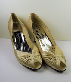 Elegant Evins ladies shoes made in Italy and purchased at Neiman Marcus in the late 1980's. Beautiful design , Champagne ivory  satin , leather,  peep open toe pumps , in excellant age related condition with a few minor soil marks (see photos) . Measures; length 9 1/2", ball of foot @ 2 3/4" , heel 3 1/4" high , U.S. ladies size AA 7 1/2 . Italian leather  and craftmanship -- Lovely ! Formal Open Toe Court Shoes, Open Toe Court Shoes With 4-inch Heel, Cream Almond Toe Court Shoes For Evening, Evening Court Shoes With 4-inch Heel And Open Toe, Cream Closed Toe Court Shoes For Evening, Cream Slip-on Heels For Formal Events, Vintage Cream Party Heels, Cream Round Toe Court Shoes For Evening, Cream Court Shoes With Round Toe For Evening