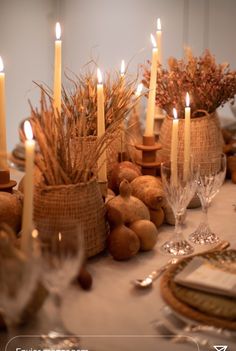 a table topped with lots of candles and dishes