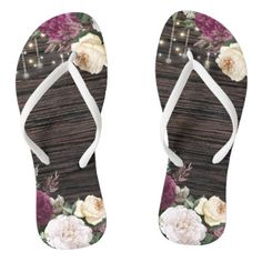 a pair of flip flops with flowers and lights on the bottom, in front of a white background