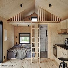 a bedroom with a ladder to the ceiling and a bed in the corner next to it