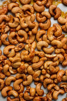 roasted cashews on a baking sheet ready to be cooked in the oven for cooking