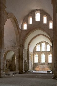 an empty church with stone arches and windows