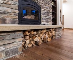 a fireplace with logs stacked on top of it