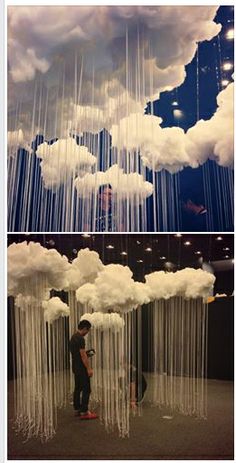 two pictures of people standing in front of clouds hanging from the ceiling and one is taking a photo