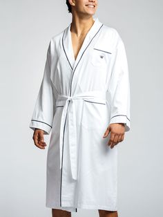 Our flagship Royal Robe was created with only one thing in mind: luxury. Crafted from our famous 400 thread-count Pima cotton, it features a shawl collar, three pockets, self-belt, navy trim, and our signature navy crown. Generously cut with a full, handsome drape, you would never know a robe could be so comfortable. DETAILS Originally made - and sized - for men, but the ladies love them too. See the Size Guide below Handmade Relaxed, easy fit 100% long-staple Pima cotton makes the fabric softer Classic Long Sleeve Robe For Daywear, Elegant Fitted Cotton Robe, Pillow Fabric, The Grove, Hair Accessories Jewelry, Book Decor, Fabric Rug, Shawl Collar, Hat Hairstyles