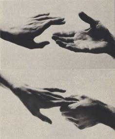 hands reaching out to touch each other with their fingertipss in black and white photo