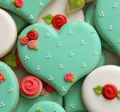 decorated cookies in the shape of hearts and roses