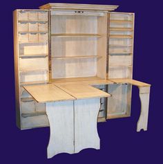 an old fashioned desk and cabinet are shown against a blue background with the door open