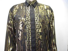 "GREEK STYLE SILK SHIRT European Style Dress Beautiful 100% Metallic Silk Shirt ,Black and Gold all over .Beautiful design . Hidden Gold Finish Buttons Men's Sizes : Small only Comfort Fit with Beautiful details all over Excellent condition Please see measurement for proper fitting or compare to one shirt that fit you good Unisex Adults TAG SIZE SMALL : Pit to Pit With the shirt lying flat : 22\" inches, Sleeve Length, measured from the top of the shoulder seam to the end of the arm cuff :23\" i Gold Long Sleeve Tops With Baroque Print, Long Sleeve Gold Tops With Baroque Print, Gold Long Sleeve Top With Baroque Print, Gold Long Sleeve Shirt With Graphic Print, Classic Gold Shirt For Party, Designer Long Sleeve Festive Shirt, Designer Fitted Gold Top, Vintage Graphic Print Party Shirt, Versace Style