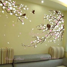 the wallpaper is decorated with flowers and birds on it's branches, as well as two birds sitting on a tree branch