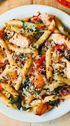 a white plate topped with pasta and chicken