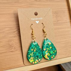 One pair of handmade teardrop-shaped earrings Made with bright, green confetti and epoxy resin  The perfect pair of groovy earrings for welcoming the warmer weathers, celebrating special moments and more! Each pair is assembled with hypoallergenic, nickel-free ear wire and safe for sensitive ears ---------------------------- RESIN CARE - Avoid long periods of direct sunlight to prevent yellowing - Wash with a very mild soap, warm water and a non abrasive cloth - Avoid submerging in water (remove Groovy Earrings, Green Confetti, Body Oils, Resin Earrings, Long Periods, Sensitive Ears, Ear Wire, Bright Green, Mild Soap