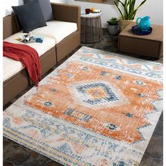 an orange and blue area rug in a living room