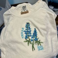 Handmade Designed By Me S-Xxl Ivory Comfort Colors Tee 5 Thread Colors Hand Drawn Bluebonnet Cotton Cream Tops With Embroidered Graphics, Cream Cotton Top With Embroidered Graphics, Casual Beige Tops With Embroidered Graphics, Spring Cream Cotton Shirt, Pre-shrunk Long Sleeve Shirt For Spring, Bluebonnet Texas, Texas State Flower, Texas Shirt, Texas Bluebonnets