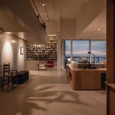 an empty room with large windows overlooking the ocean