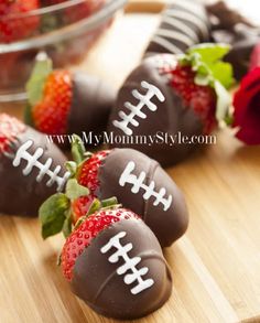 chocolate covered strawberries are arranged on a cutting board