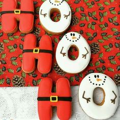 three decorated doughnuts with santa hats on them and one donut in the middle