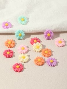 colorful flowers are arranged on a white surface