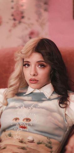 a woman with long hair sitting on a red couch