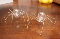 three light bulbs sitting on top of a wooden table