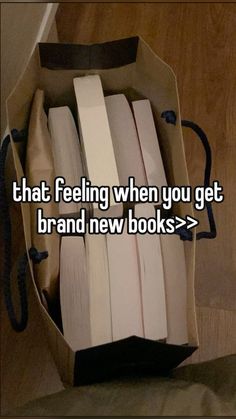 an open book in a bag with the words that feeling when you get brand new books