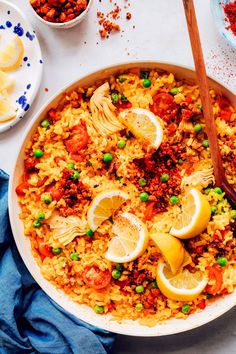 a large bowl filled with rice and lemons