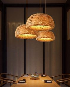 a wooden table topped with lots of lights hanging from it's ceiling over it