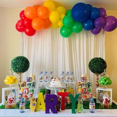 a table topped with balloons and cake