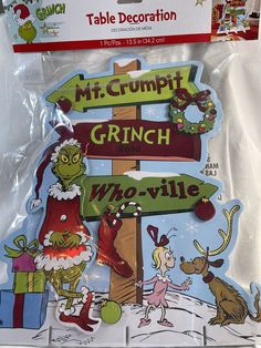 the grinch christmas sign has been decorated with santa's helper and mrs claus